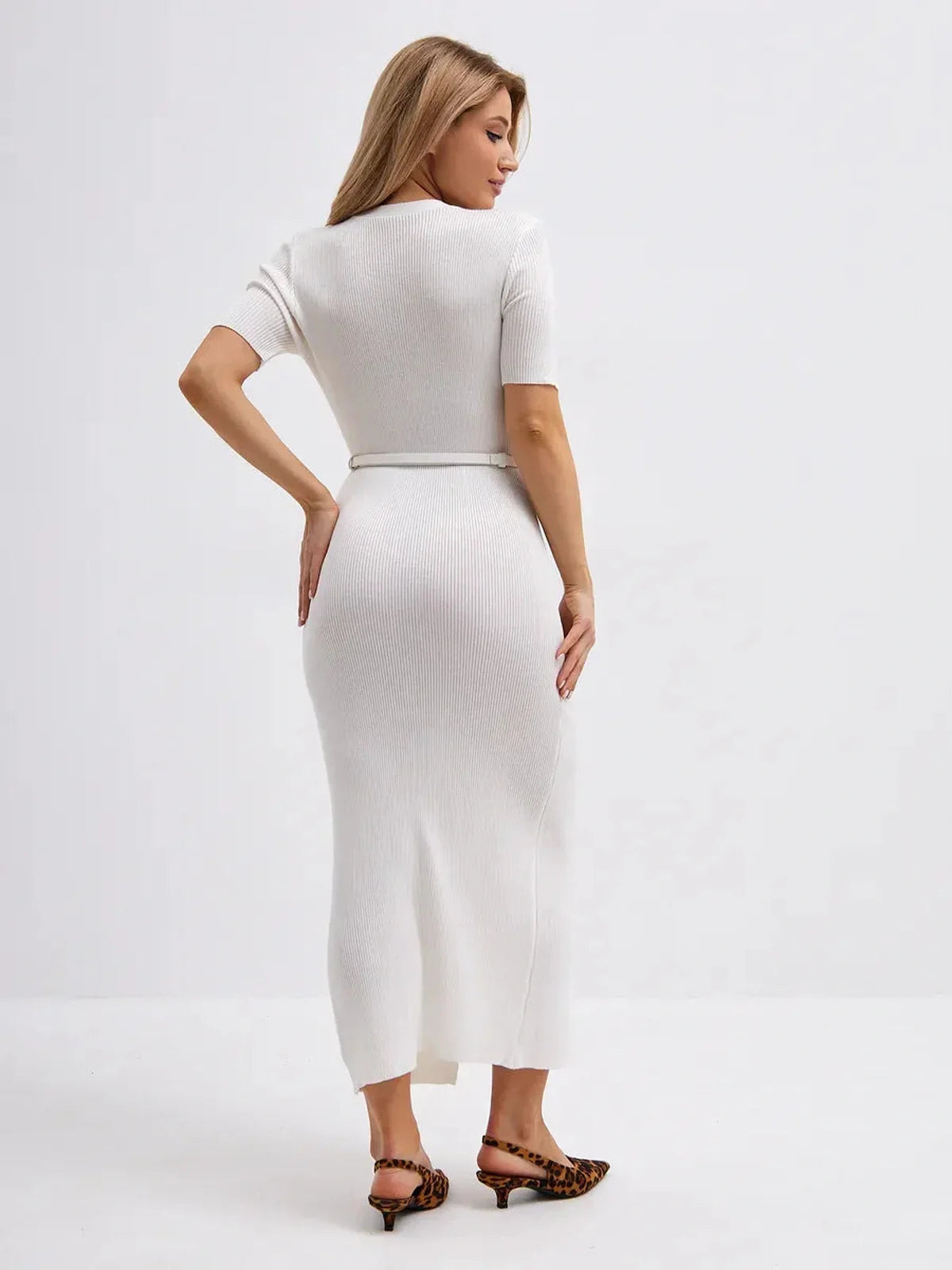 Back view of a woman wearing a white Sculpted Charm Midi Dress, featuring a belted design and elegant silhouette.