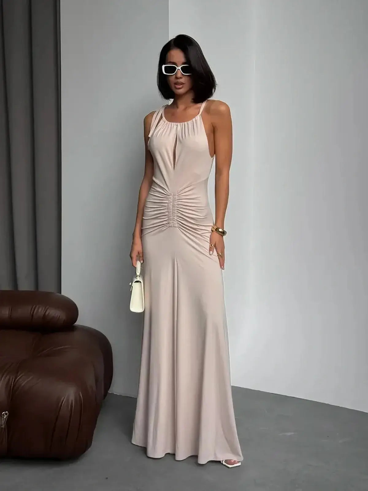 Elegant Serene Curve Maxi Dress in soft beige with ruched detailing, perfect for summer occasions, weddings, and formal events.