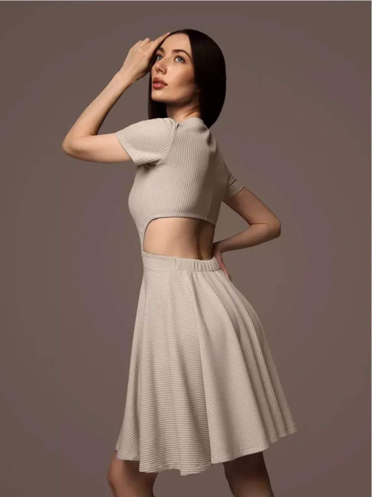 Model showcasing Breezy Hour mini dress with open back design, perfect for summer weddings and casual outings.