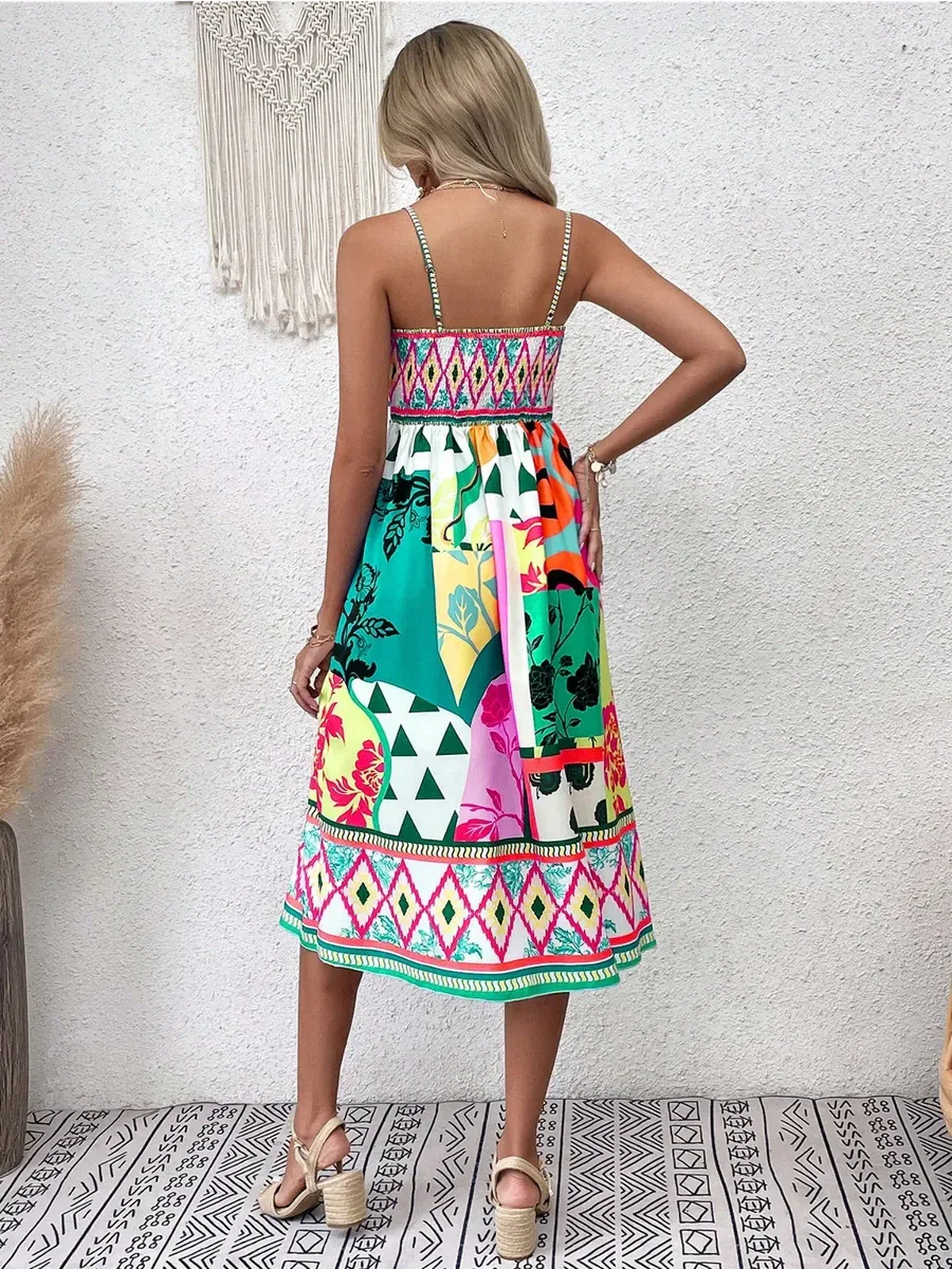 Back view of a model in a colorful Tropica Muse Midi Dress, showcasing its vibrant bohemian patterns.