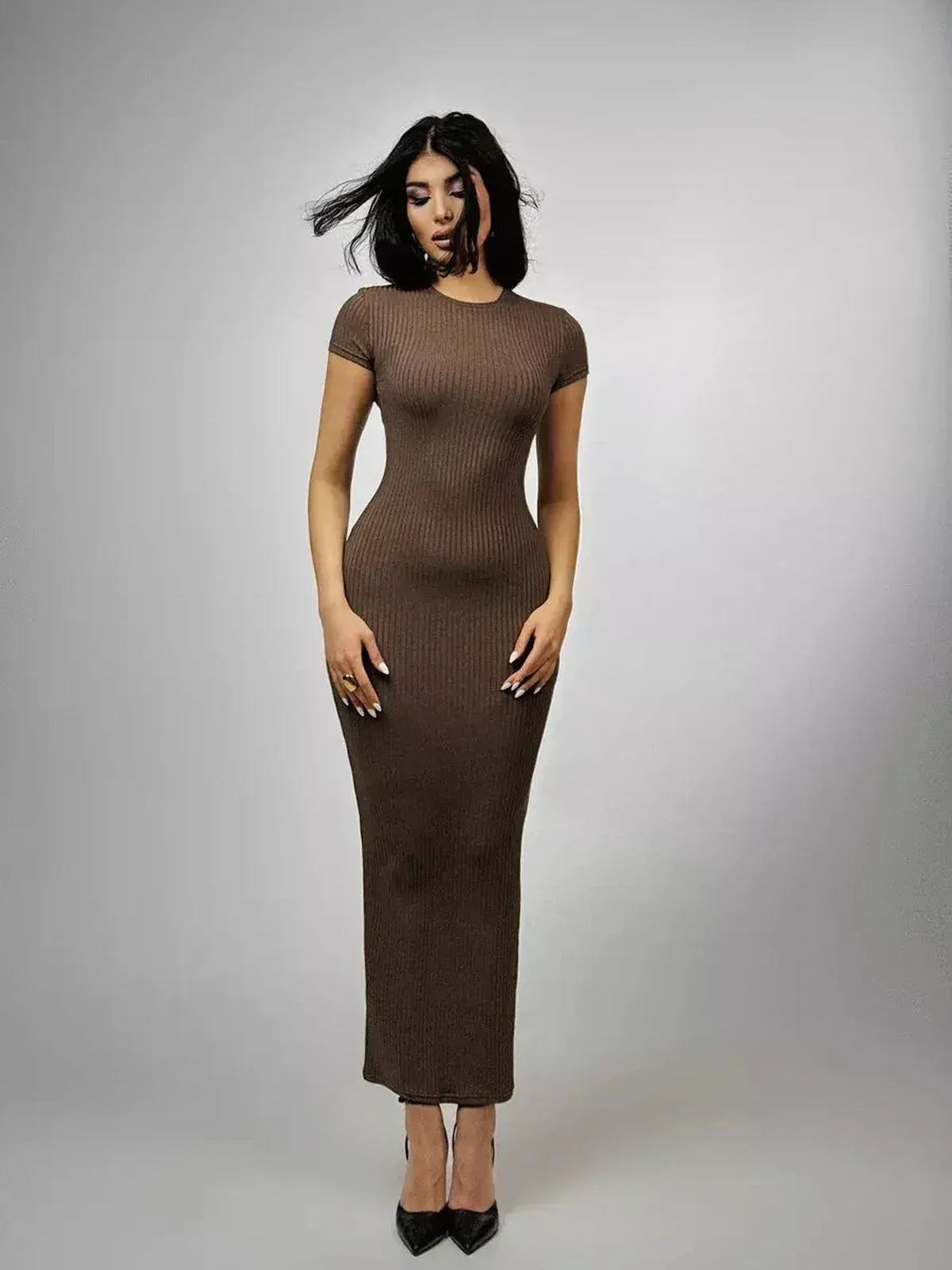 Chocolate-hued maxi dress with ribbed texture and sleek silhouette, perfect for wedding guest and formal occasions.