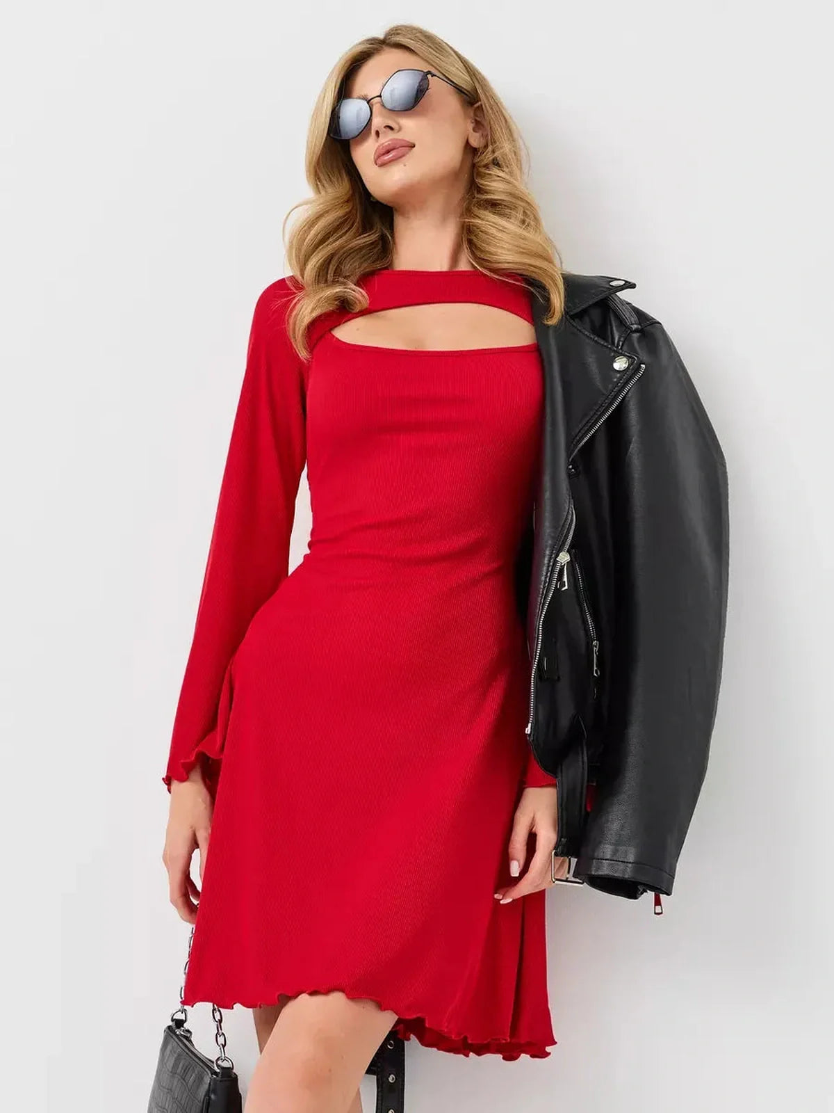 Stylish woman in a red flare cutout mini dress paired with a leather jacket, perfect for summer or wedding guest attire.