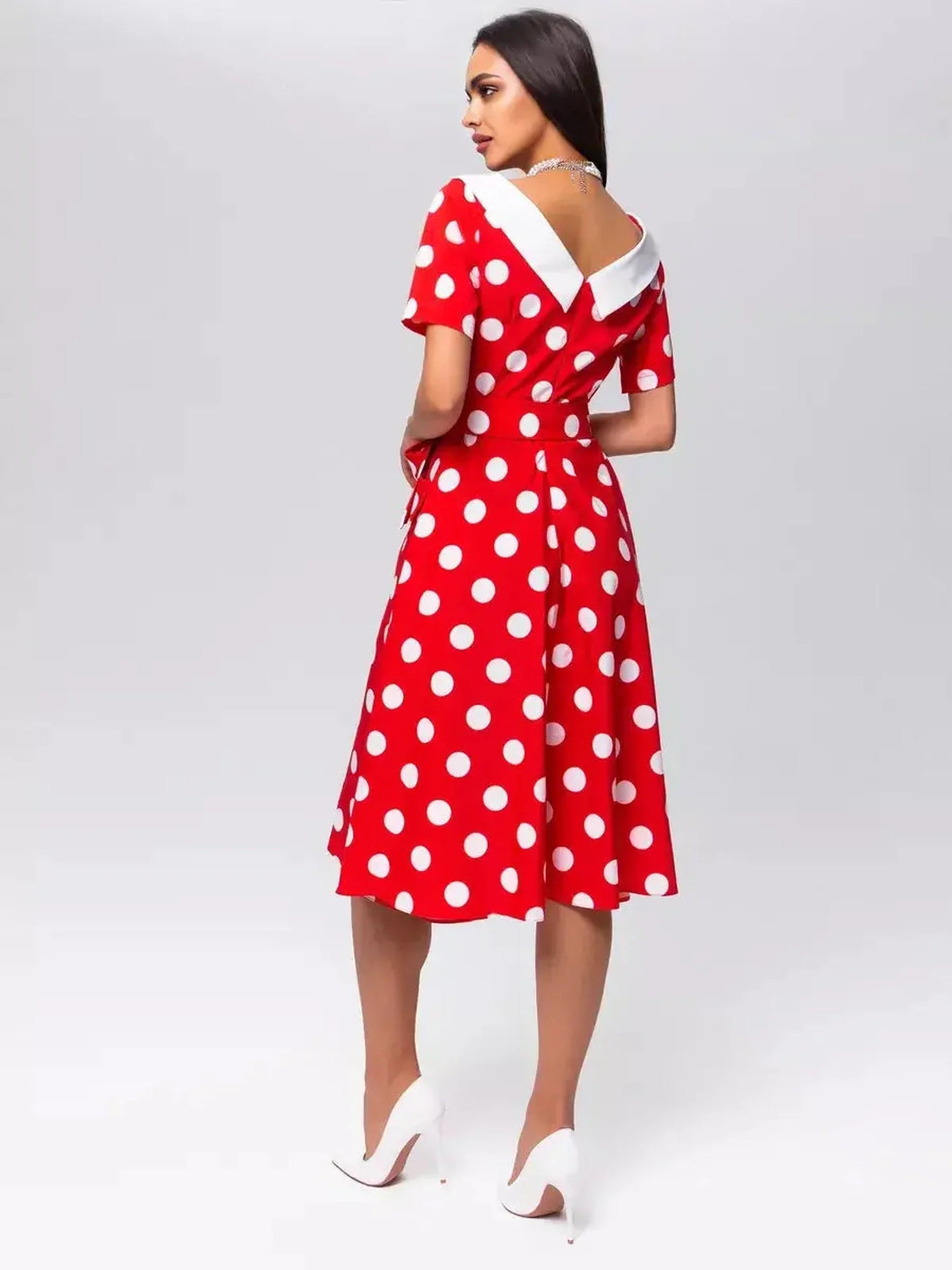 Back view of a red and white polka dot midi dress with a white collar, perfect for summer weddings or formal events.