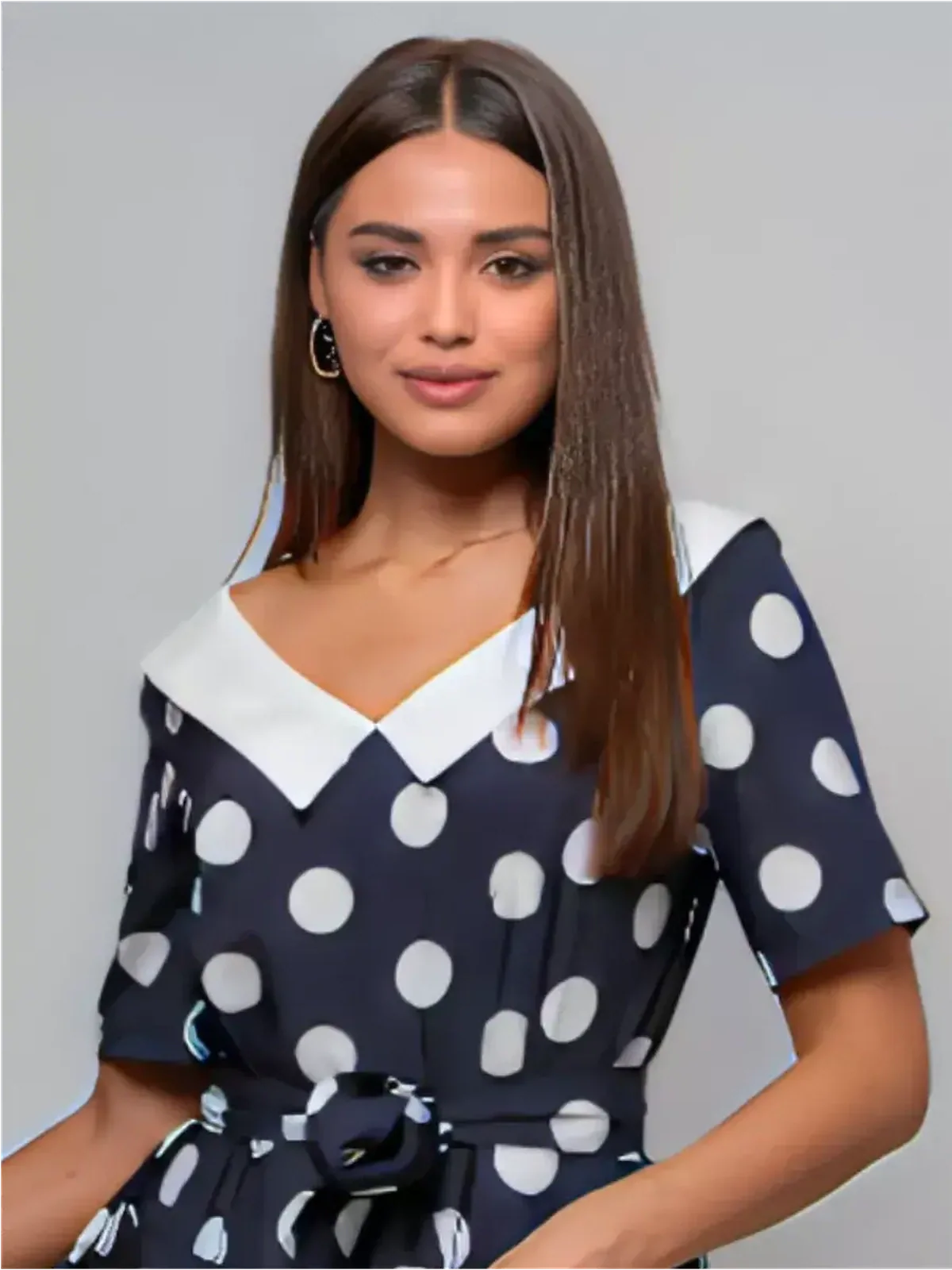 Model wearing a Nautical Charm Midi Dress with polka dots and white collar, perfect for summer events and weddings.