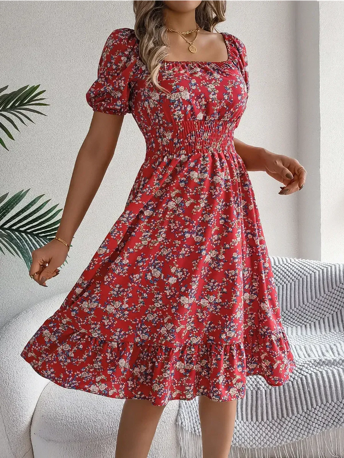 Red floral mini dress with puff sleeves and ruffled hem; perfect for summer gatherings and casual outings.