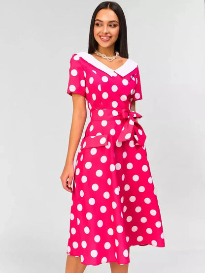Monaco Charm Midi Dress in pink with white polka dots, featuring a collar and tie waist for a chic retro look.