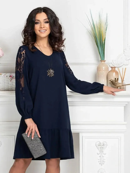 Model showcasing the Midnight Bloom mini dress in deep navy with lace accents, perfect for wedding guest or cocktail events.