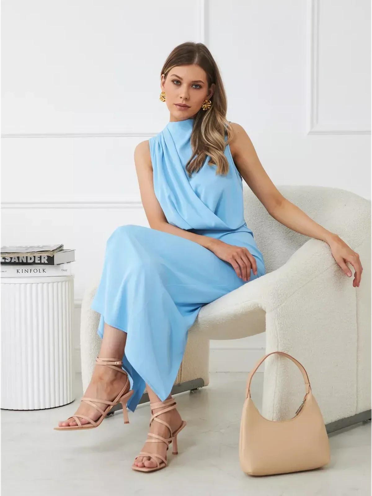 Sculpted Grace Maxi Dress in light blue, featuring a sleek draped silhouette, styled with elegant accessories.