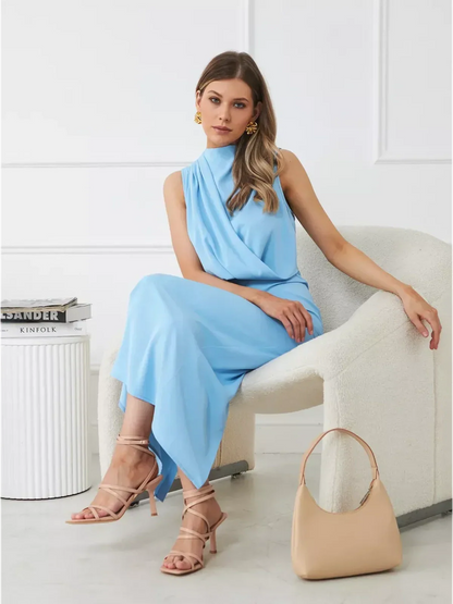 Sculpted Grace Maxi Dress in light blue, featuring a sleek draped silhouette, styled with elegant accessories.