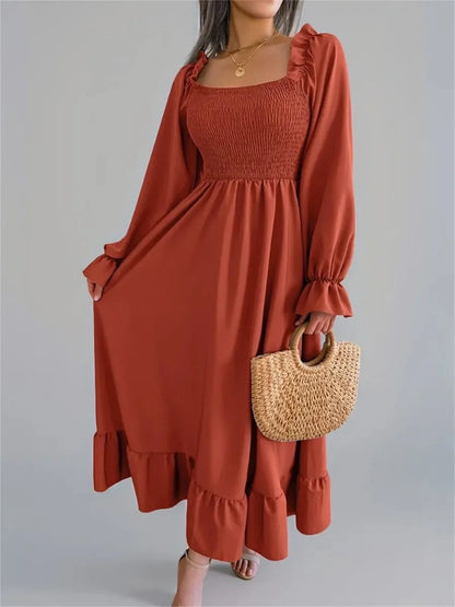 Rust Charm Midi Dress showcasing a smocked bodice and flowy skirt, ideal for weddings, summer events, and casual outings.