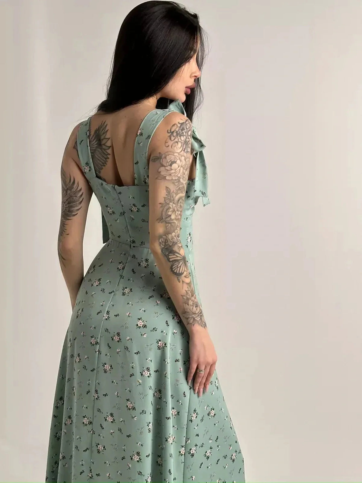 Elegant back view of the Flora Grace Midi Dress showcasing floral print and statement shoulder ties, perfect for summer events.