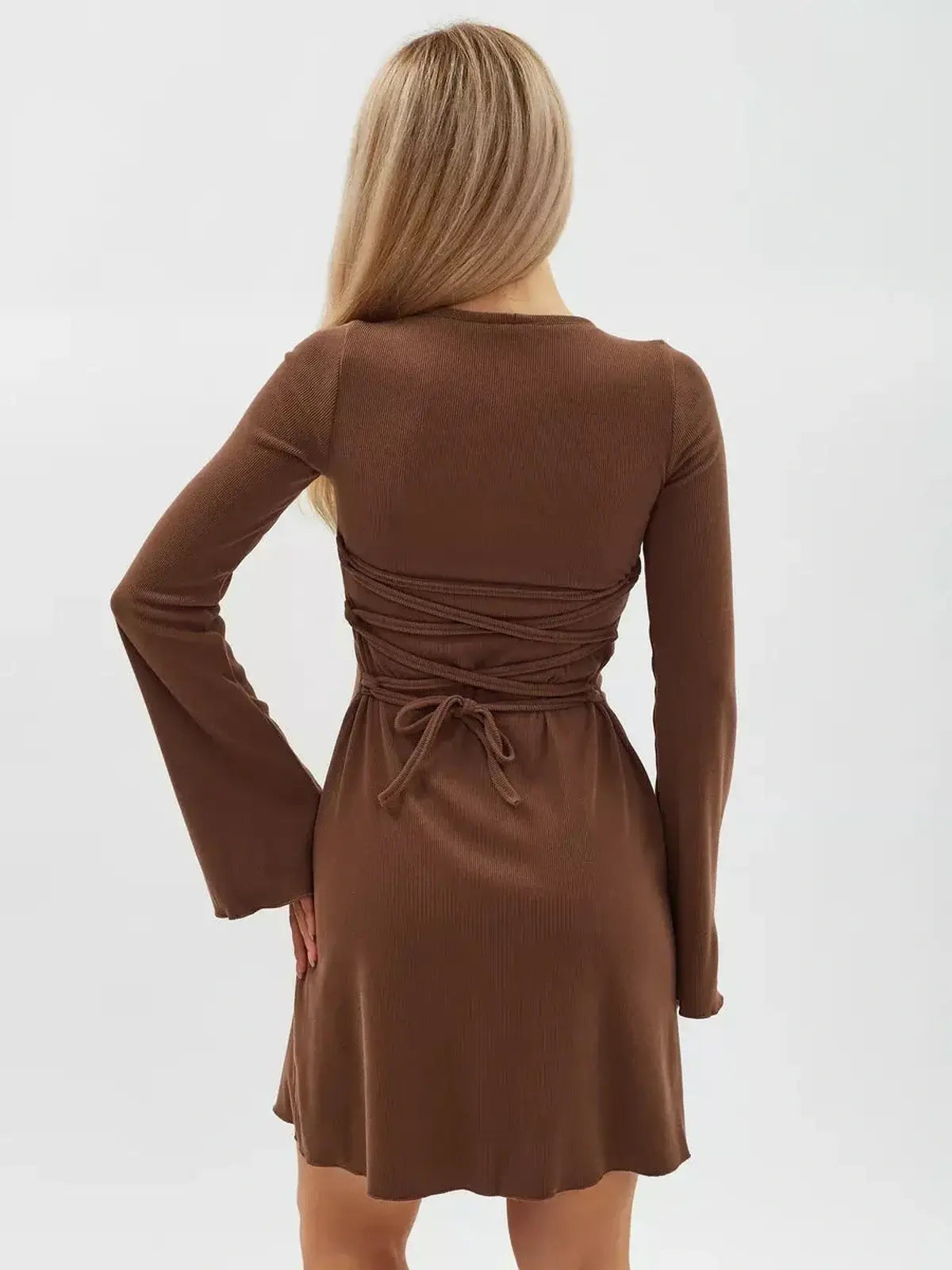 View of the Cocoa Tie Mini Dress showcasing back lace detail and flared sleeves in rich chocolate color.