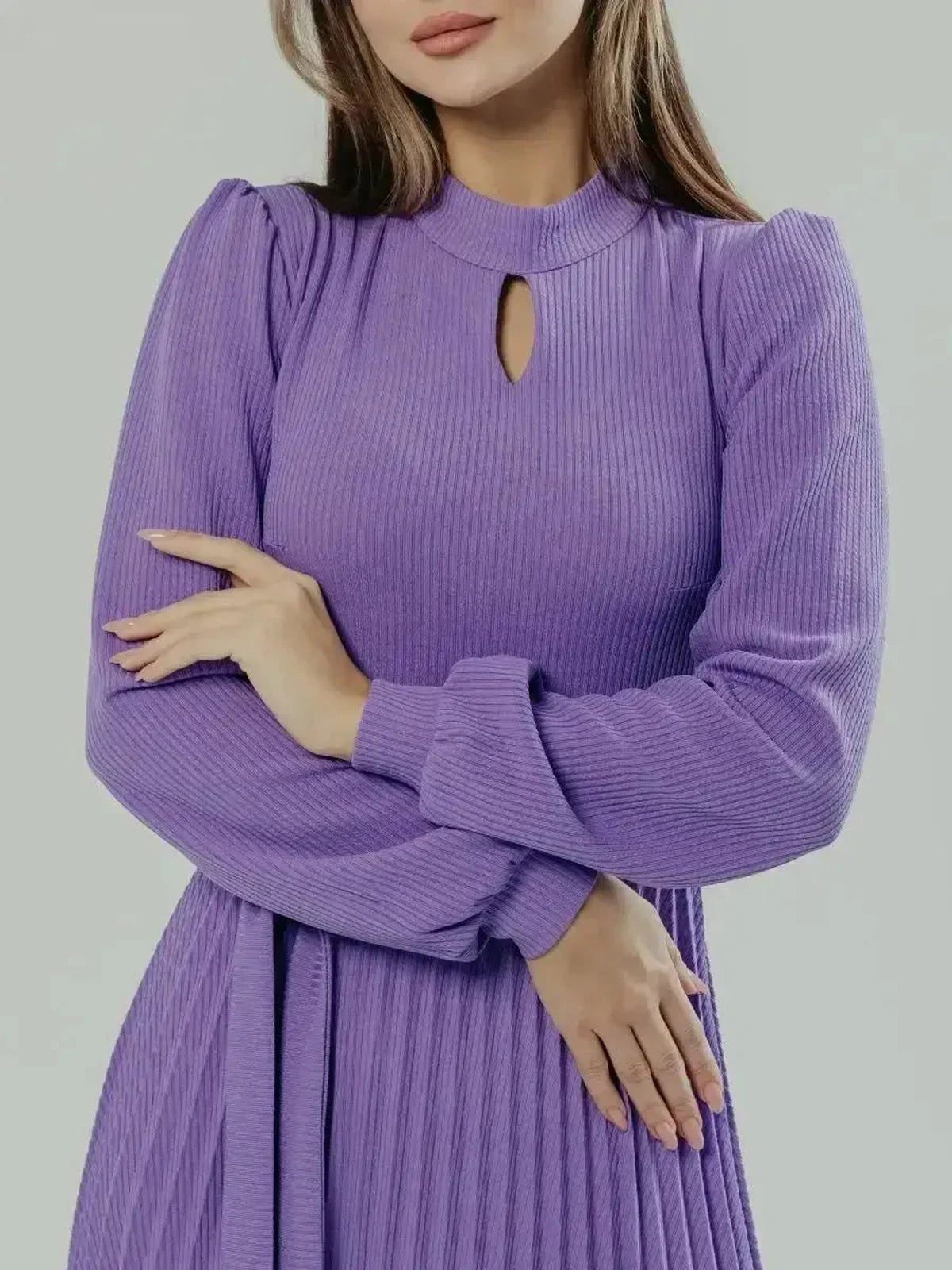 Close-up of a woman in a violet Serena Midi Dress featuring a keyhole neckline and elegant pleated sleeves.