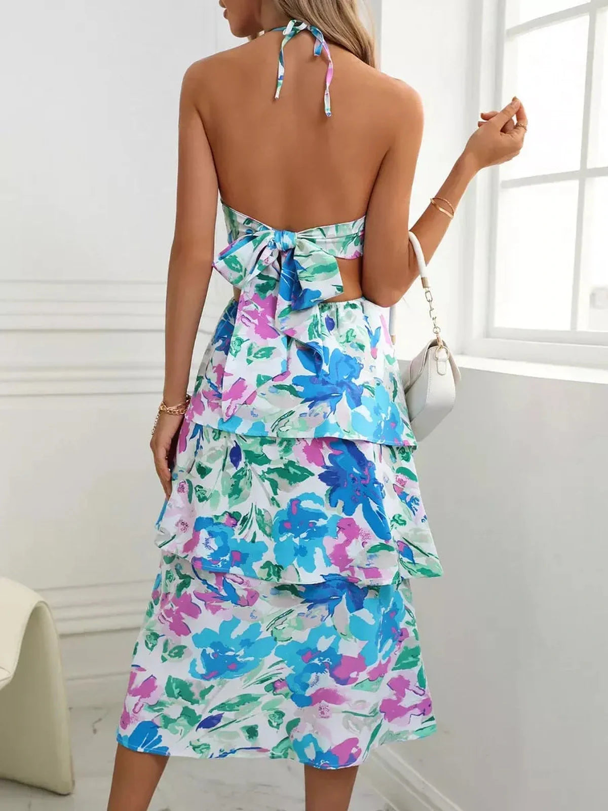 Back view of Petal Bloom Midi Dress featuring vibrant floral print, perfect for summer weddings and special occasions.