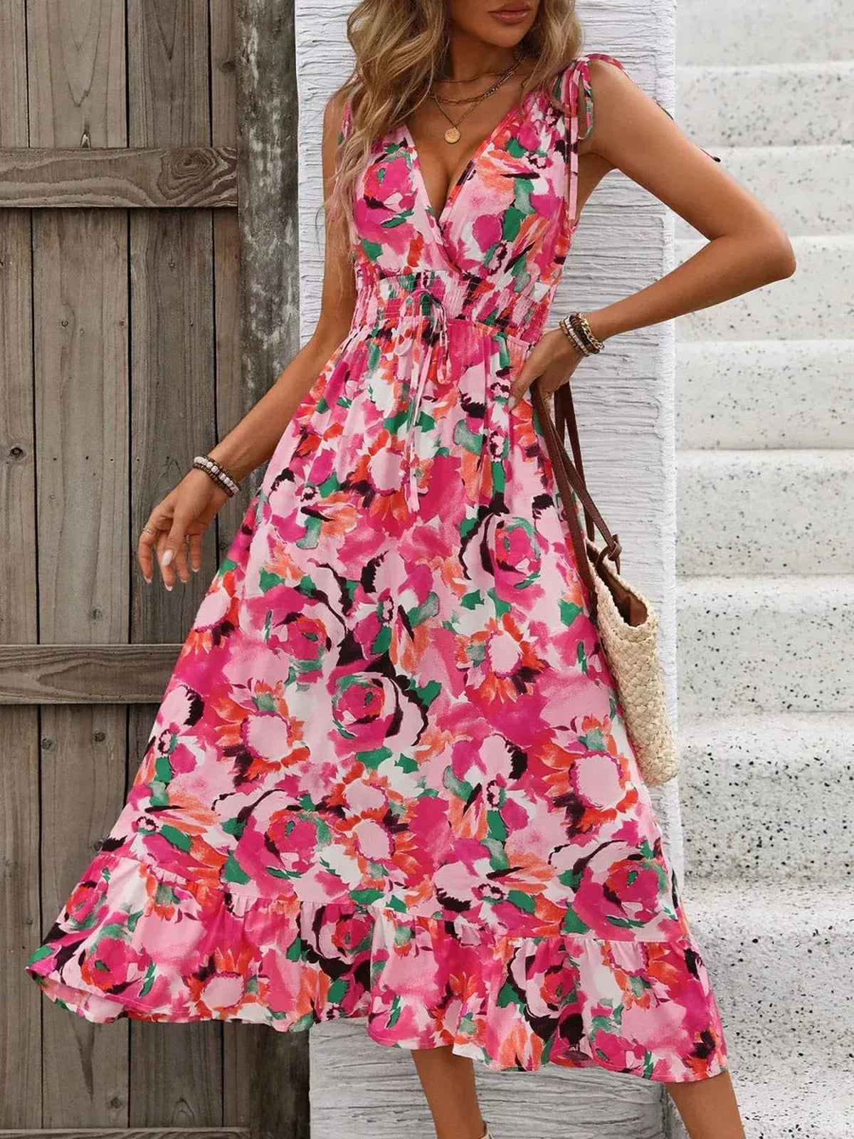 Vibrant pink floral midi dress with a strappy neckline, perfect for summer, weddings, and casual outings.