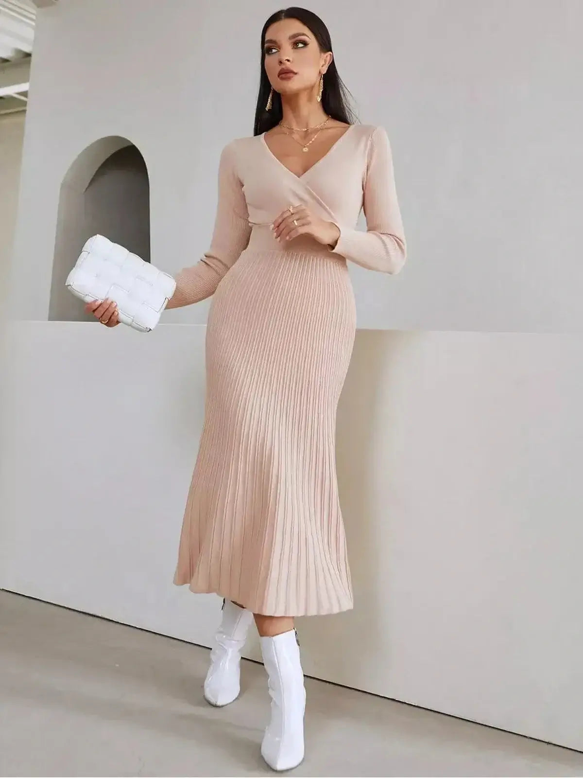 Elegant Blush Grace Midi Dress with a ribbed knit design, perfect for weddings or formal occasions, styled with white boots.