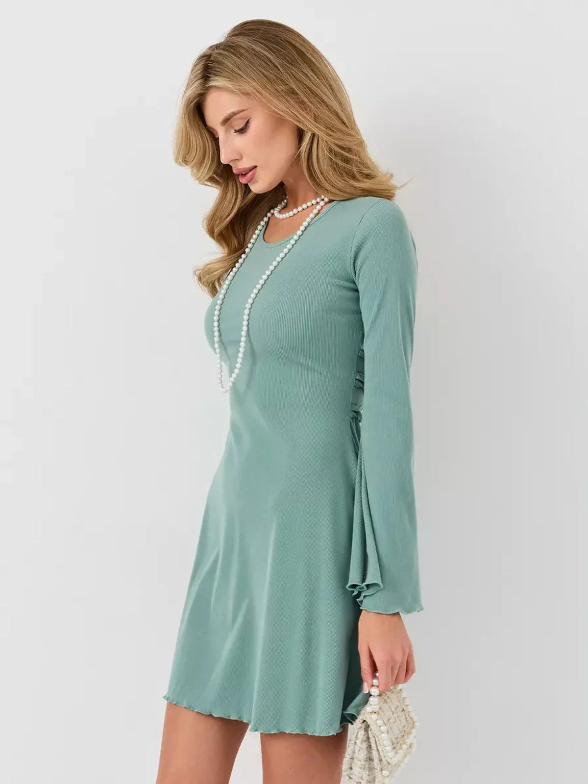 Mint Sculpt Mini dress in soft green, featuring long sleeves and an A-line cut for a chic summer look.