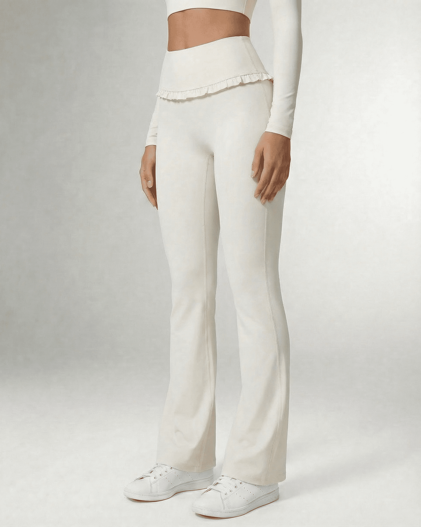 Celeste Leggings by Slimona, elegant white flare pants with pockets and ruffle details, perfect for stylish comfort.