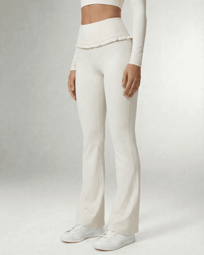 Celeste Leggings by Slimona, elegant white flare pants with pockets and ruffle details, perfect for stylish comfort.