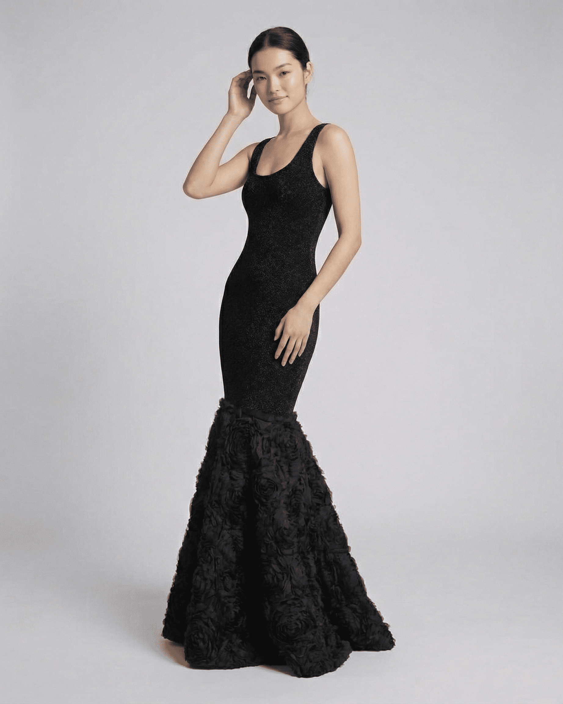 Slimona Nocturne Maxi Dress featuring a sculpted black silhouette with textured hem detail.