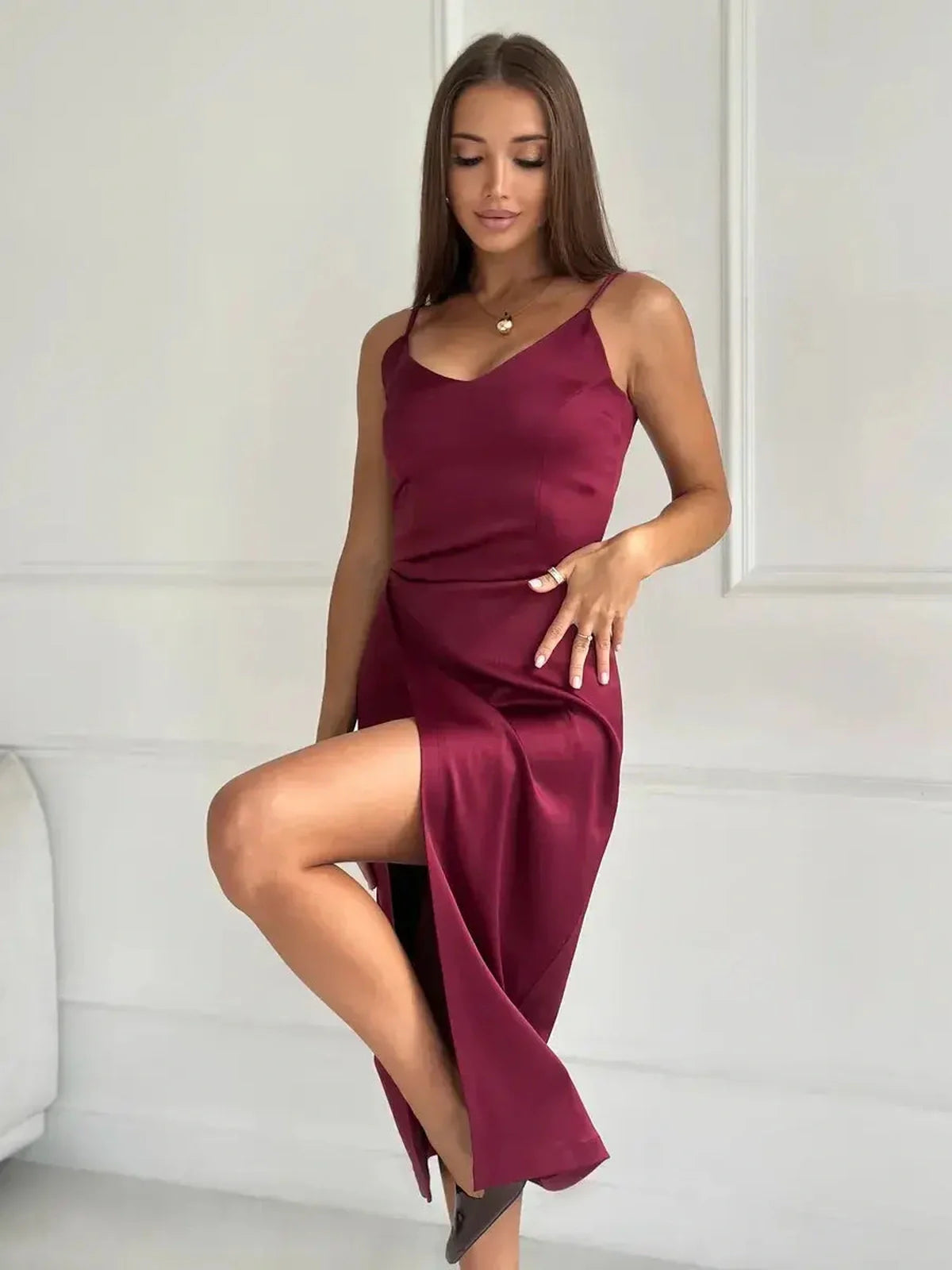 Crimson Luxe Midi Dress in glossy burgundy satin with a sultry side slit, ideal for weddings and formal occasions.