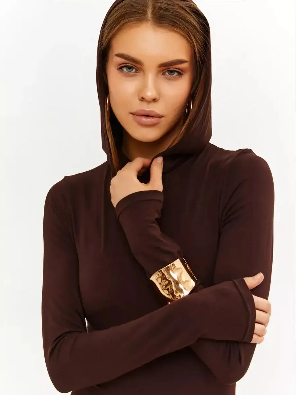 Model wearing a hooded Sculpt Maxi Dress in chocolate, showcasing modern elegance and sleek style.