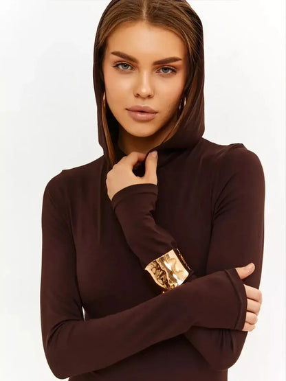 Model wearing a hooded Sculpt Maxi Dress in chocolate, showcasing modern elegance and sleek style.