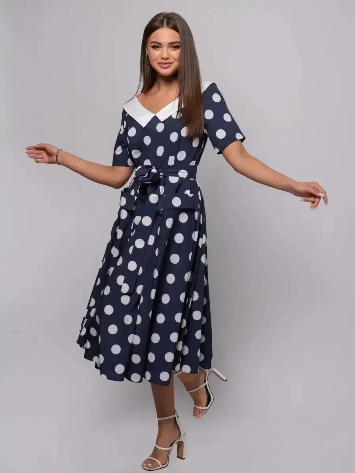Nautical Charm Midi Dress featuring polka dots, a belted waist, and a flared skirt, ideal for summer events and guests.
