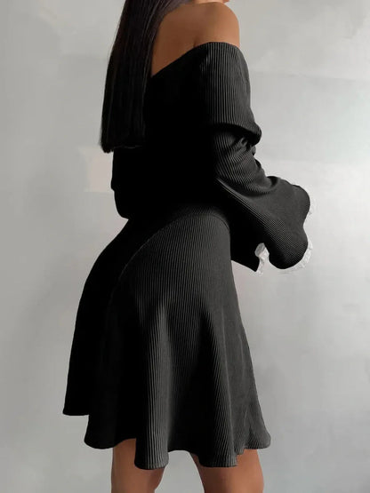 Off-shoulder black velvet mini dress with flared sleeves, perfect for summer parties and special occasions.