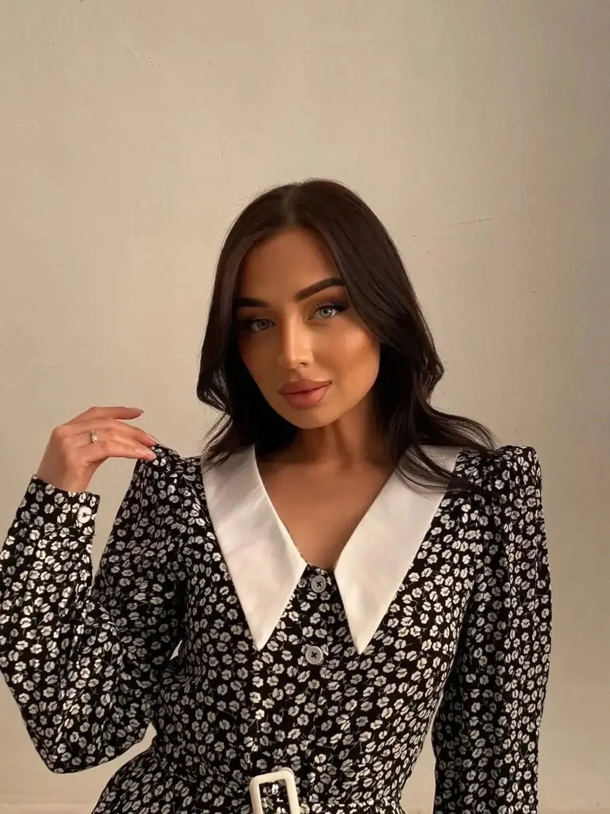 Model showcasing the Vintage Charm Mini Dress, featuring floral print, contrast collar, and button-down front.