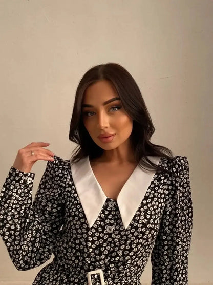 Model showcasing the Vintage Charm Mini Dress, featuring floral print, contrast collar, and button-down front.