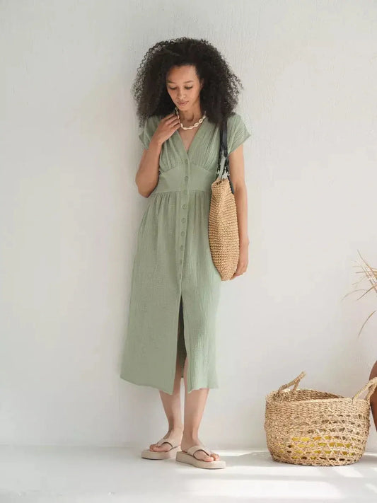 Model wearing the Verdana Midi Dress in soft khaki, showcasing a flattering corset-inspired fit and V-neckline.