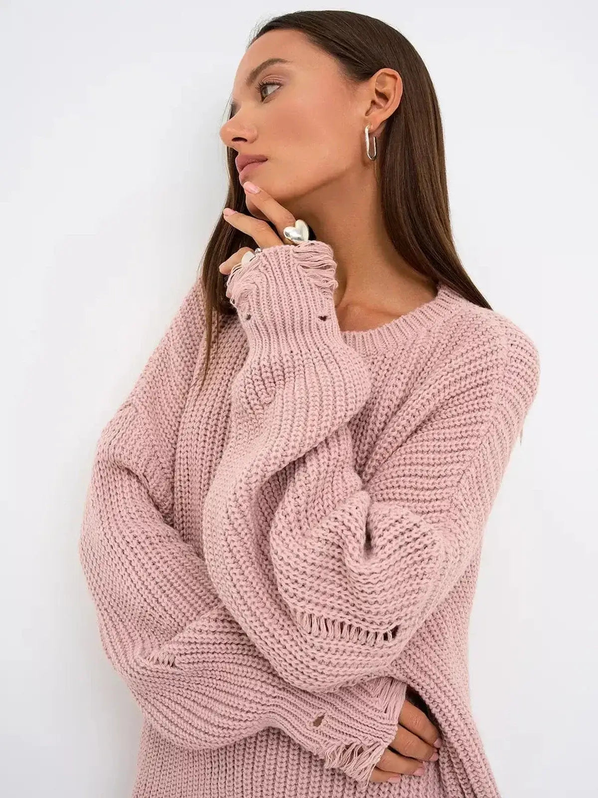 Model wearing blush edge mini dress in dusty pink knit, showcasing oversized fit and distressed design.