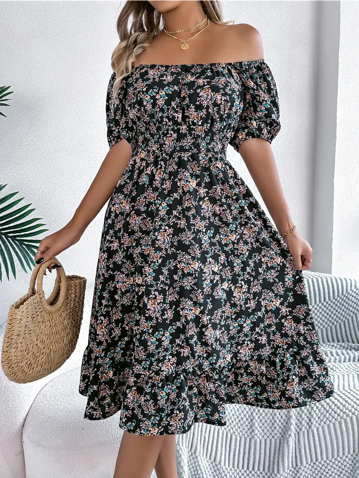 Black off-shoulder floral dress with ruffled hem, perfect for summer events and casual outings.
