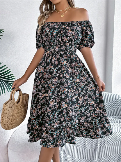 Black off-shoulder floral dress with ruffled hem, perfect for summer events and casual outings.