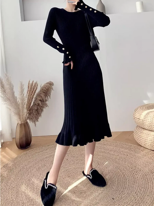 Sculpted Pearl Midi Dress in black, featuring ribbed knit, flared cuffs with pearl buttons, and ruffled hem, perfect for weddings and formal events.