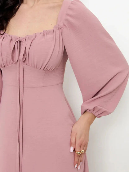 Close-up of the Blush Charm Midi Dress featuring romantic puff sleeves and a flattering square neckline.