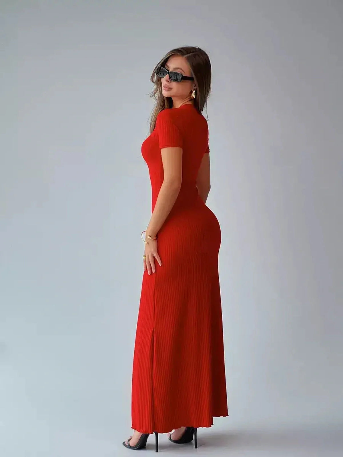 Elegant red ribbed maxi dress sculpted to fit, perfect for summer events and wedding guest attire.