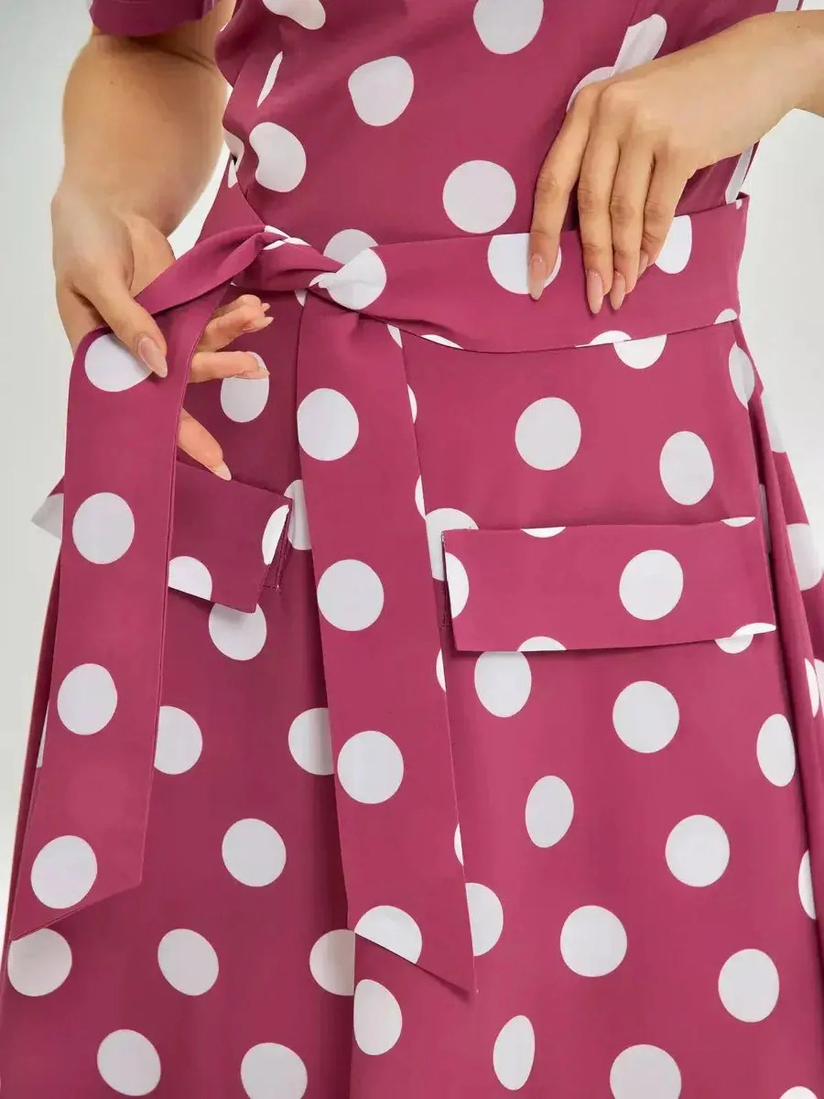 Close-up of the Retro Dot Midi Dress showcasing polka dots and a stylish waist tie, perfect for summer outfits.