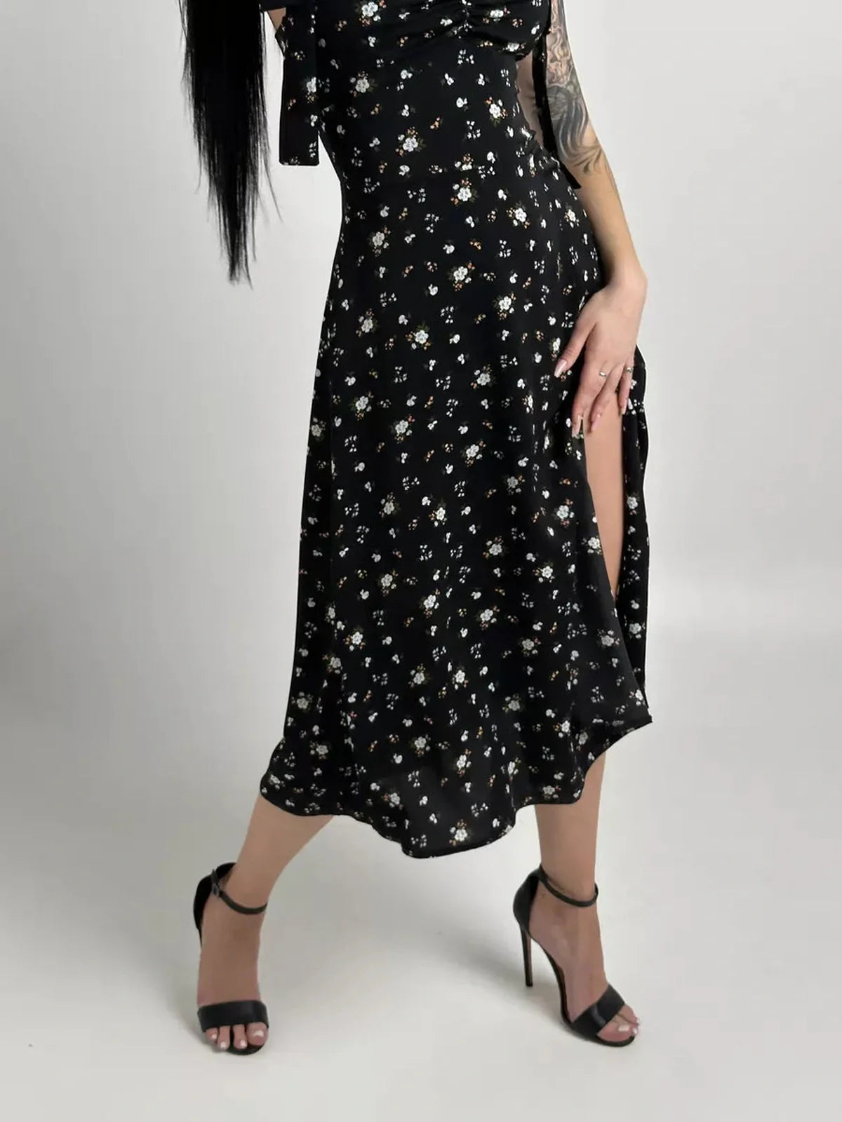 Elegant black floral Elysian Midi Dress featuring romantic bows and a stylish slit, perfect for summer occasions.