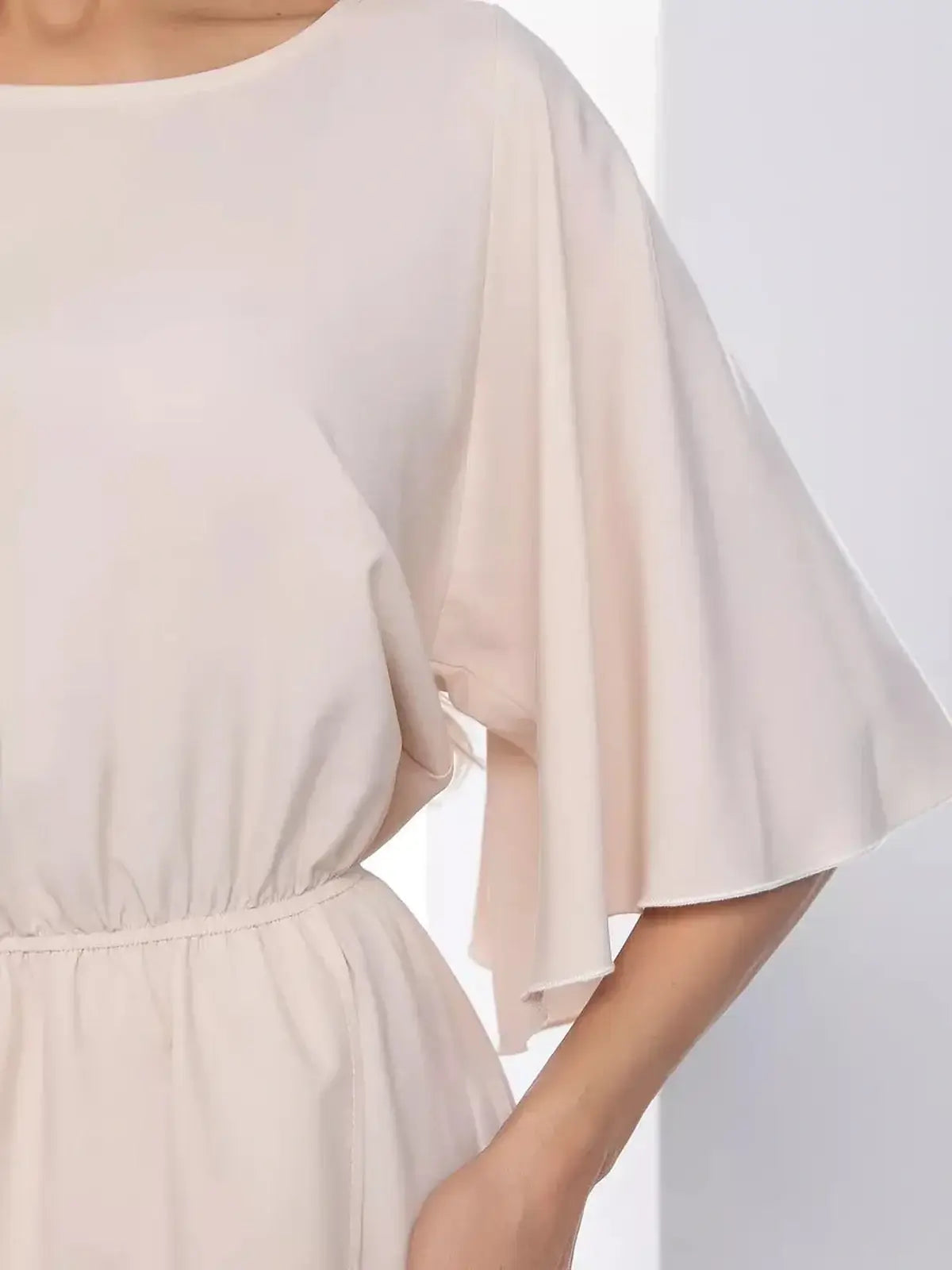 Close-up of the Serenity Midi Dress showcasing soft flared sleeves and a belted waist for a feminine silhouette.