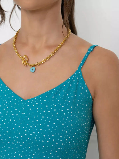 Close-up of turquoise Serenity Maxi Dress showcasing adjustable straps and a gold necklace, perfect for summer occasions.