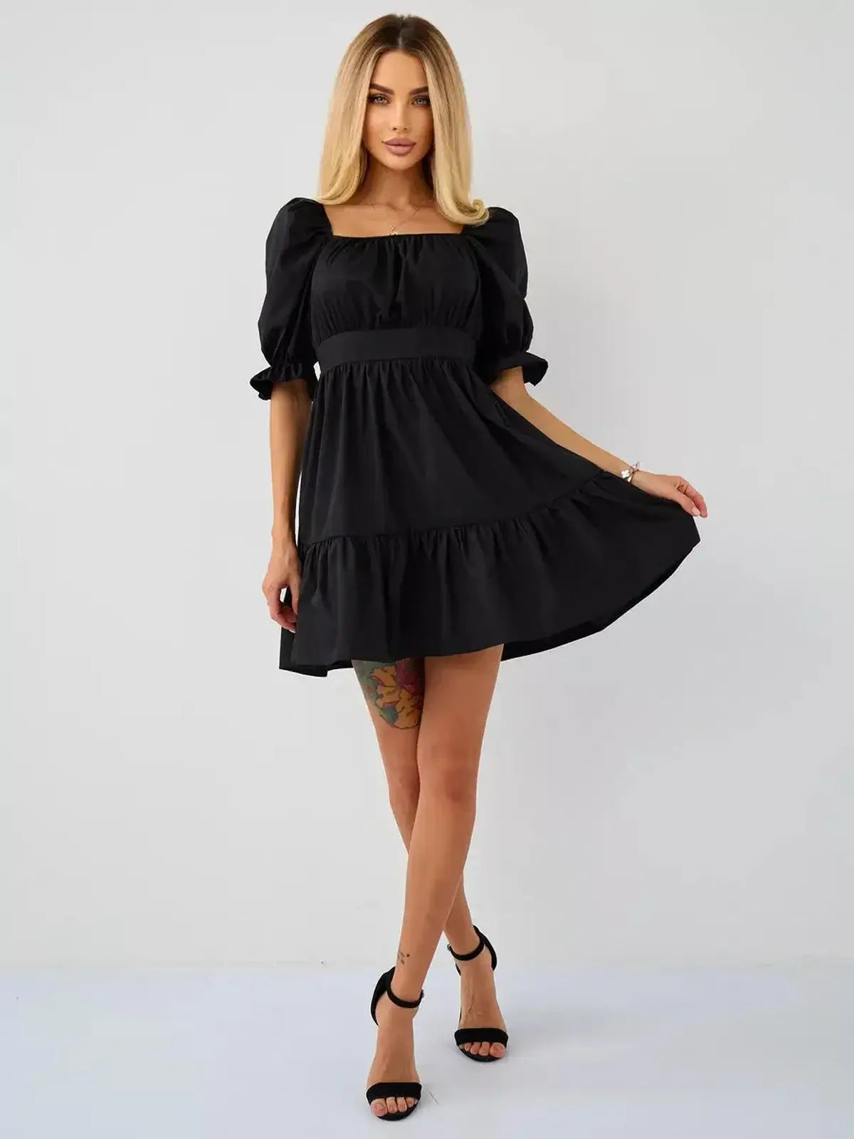 Stunning black mini dress with puff sleeves and square neckline, perfect for summer events and wedding guest attire.