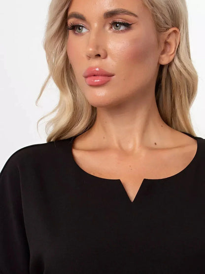 Close-up of a model showcasing the subtle rounded neckline of the Modern Grace black mini dress.