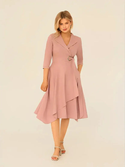 Blush Charm Midi Dress featuring a wrap-front design, asymmetric hem, and ring buckle waist, ideal for weddings and formal events.