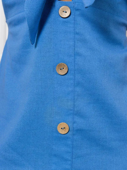 Close-up of the blue fabric and button details on the Maxi Dress Azure Charm, showcasing its stylish V-neckline.