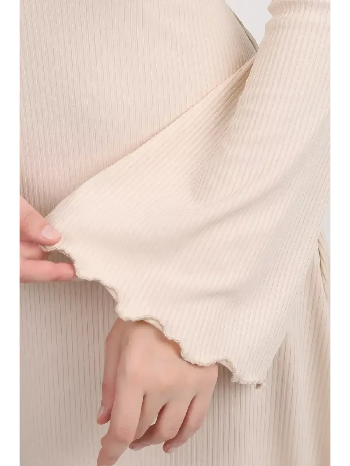 Close-up of the flared bell sleeve of the Ivory Flow Midi Dress showcasing its soft ribbed texture.