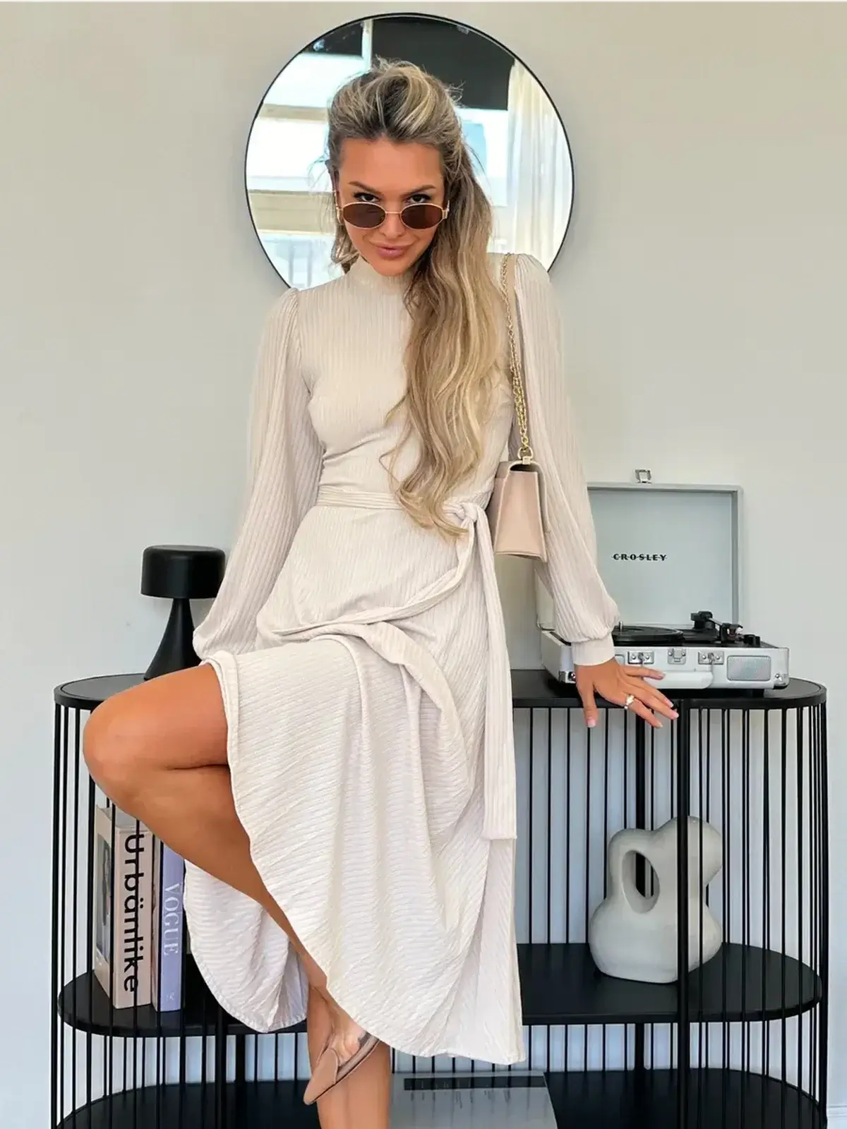 Ivory Whisper Midi Dress featured on a model, showcasing a ribbed knit design and stylish flowing skirt.