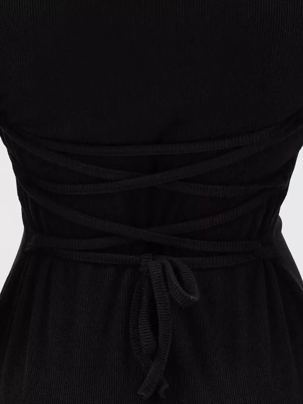 Back view of a Noir Flare Mini Dress featuring a tie waist and crisscross detail, perfect for elegant occasions.