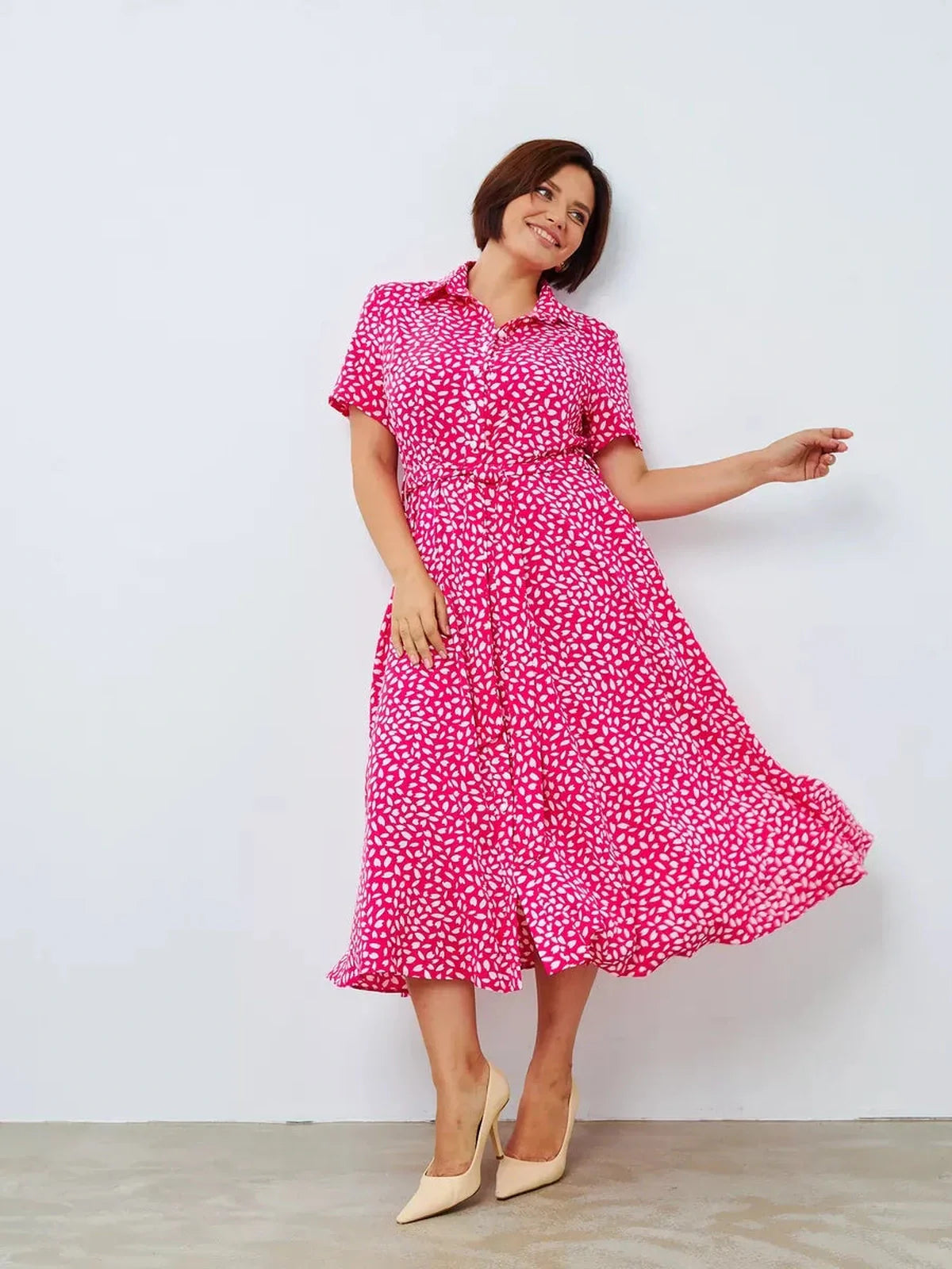 Bright fuchsia midi dress with white petal print, perfect for summer, weddings, and casual outings.